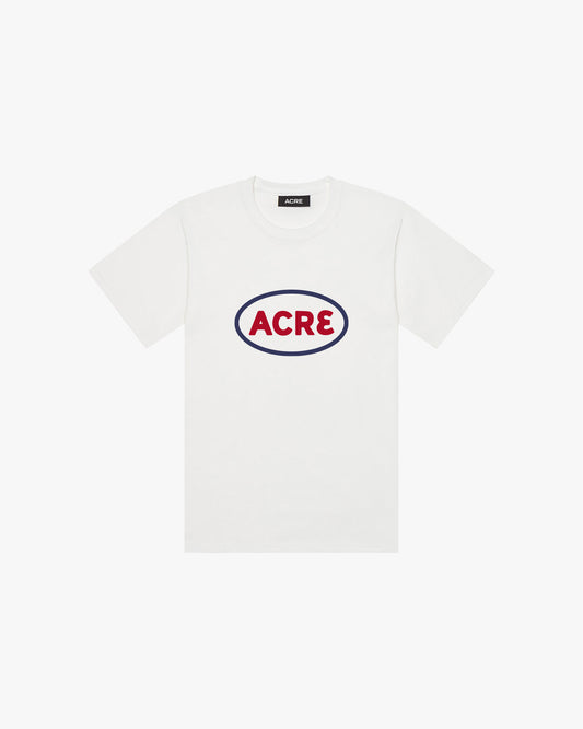 A white t-shirt with "Acre" printed on the chest in red around a blue oval.